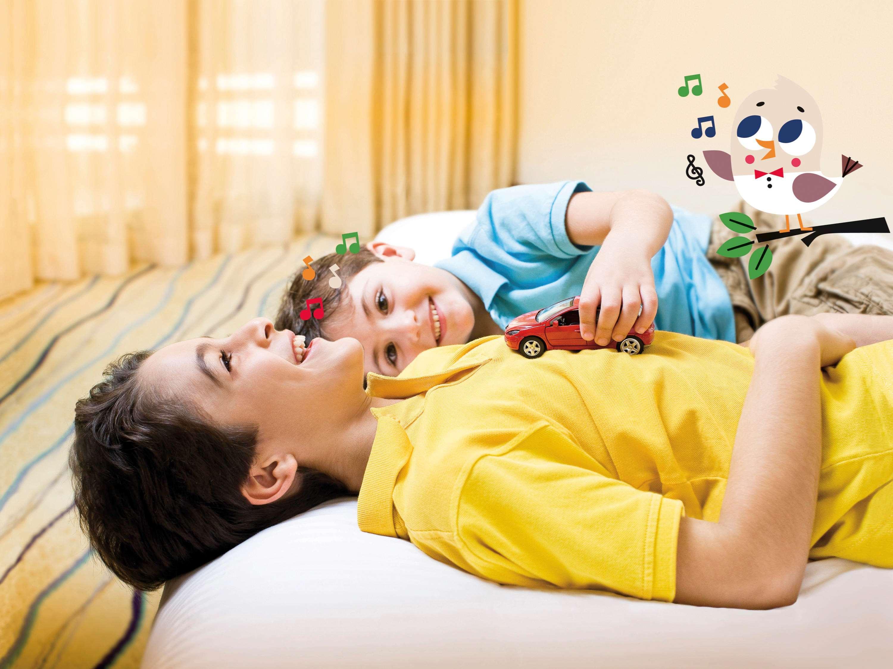 Mövenpick Hotel&Casino Malabata Tanger Esterno foto A child with autism playing with a toy